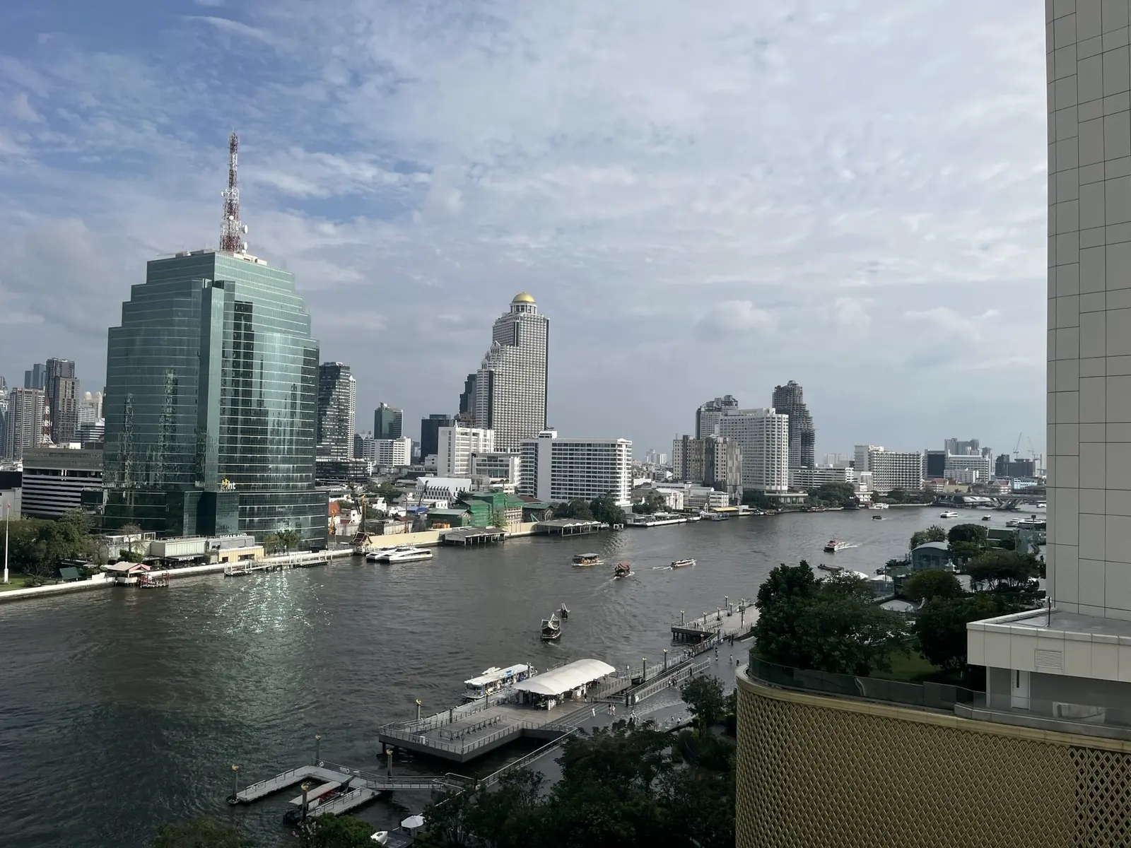 The Chao Phraya river with boats and Bangkok towers